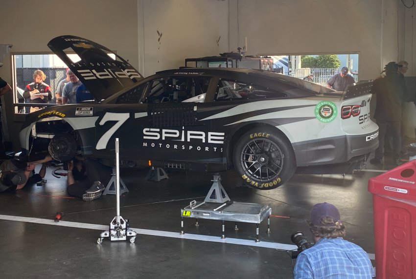 Corey LaJoie's #7 Spire Motorsports Chevrolet receives service before making a test run.